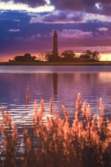 Photo art by Jean Claude Castor: Flügge lighthouse at sunset by the Baltic Sea.