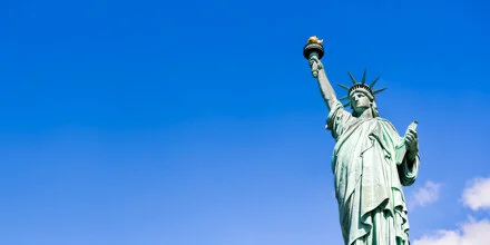 Photo art by Jan Becke: Statue of Liberty against a bright blue sky.