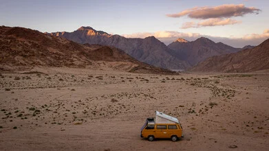 Fotokunst von Jens Brinkmann: VW Bus in der Wüste mit Sonnenuntergang im Hintergrund.