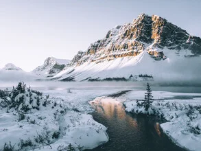 Gentle winter landscape with snow-covered mountains and calm lake