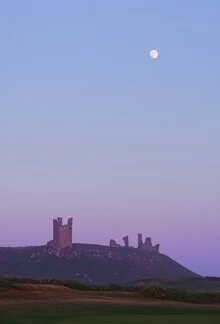 Moon over Dunstanburgh Castle - Fineart photography by Alex Wesche