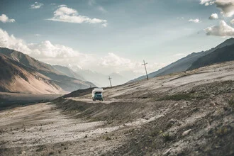 Wilderness with an expedition vehicle surrounded by majestic mountains in Tajikistan.