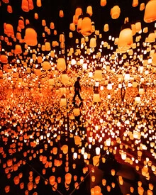 Photo of red lights in Tokyo with soft reflections on a water surface