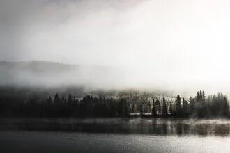 Sunrise in autumn over a lake with gentle fog swirls