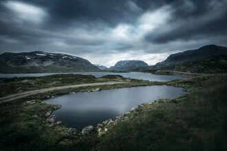 Photo art by Felix Baab: tranquil mountain lake beneath dark clouds