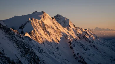 Photo art by Clemens Bartl: serene view of a sunset over the mountains