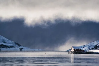 Photo art by Victoria Knobloch: House by the fjord under a blanket of clouds in Norway.