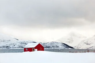 Photo art by Victoria Knobloch: red hut in snow against a winter fjord landscape