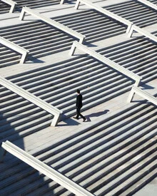Photo of a man on stairs in Barcelona, calm architectural scene