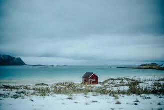 Lonely house in Lofoten, Norway, surrounded by dramatic clouds and sea