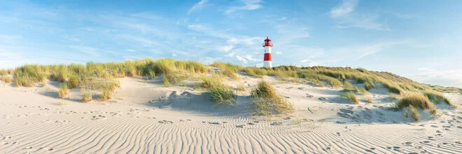 Dune landscape with a lighthouse on Sylt, a tranquil summer coastal view