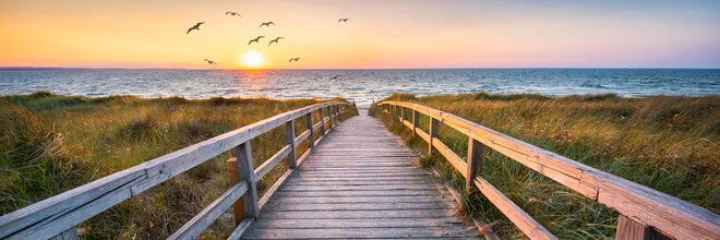 Sunset at the beach with gentle waves and warm colors