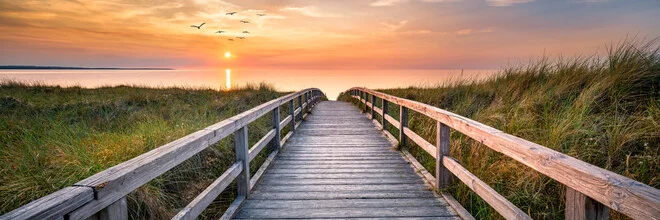 Beautiful sunset over the dune beach with gentle waves.