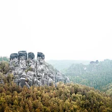 Photo art by Dennis Wehrmann: sandstone mountains in morning fog.