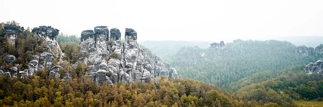 Morning fog over sandstone mountains in Saxony.