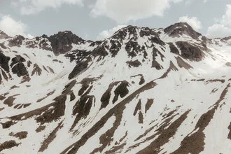 Photo art by Roman Becker: snow-covered mountain peak under cloudy sky
