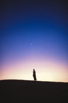 Star gazer in the desert: relaxed person under the moon in Oman