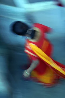 Photo art by Gerhard Blücher: an Indian woman in traditional attire against a colorful backdrop