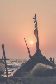 Beautiful beach sunset with gentle waves and a pink sky