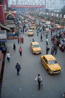Train station in Calcutta with taxis and people on the street, calm atmosphere