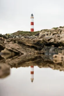 Photo art by Lars Brauer: lighthouse on cliffs, calm reflection in the water