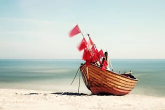 Photo art by Manuela Deigert: stranded boat under a flag by the Baltic Sea.