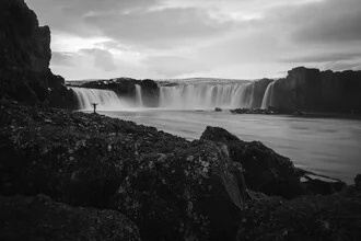 Photo art by Max Saeling: tranquil waterfall surrounded by stones in Iceland.
