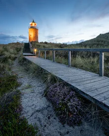 Photo art by Ronny Behnert: lighthouse at dusk over the North Sea.