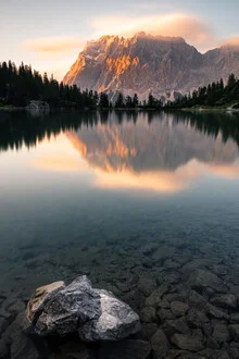 Photo art by Thomas Kleinert: calm sunset over mountains with reflection in the lake.