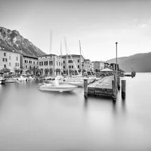 Beautiful sunrise over Lago di Garda in Gargnano, calm water surface.