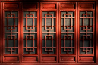 Photo art by AJ Schokora: warm light and shadow under a carved window