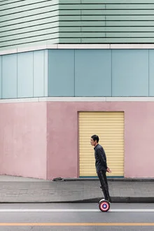 A man rides a hoverboard leisurely through the streets of Shanghai.