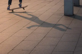 Photo of a skater in shadow, illuminated by the evening sun
