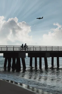Sun rays break through clouds over the pier in Singapore.