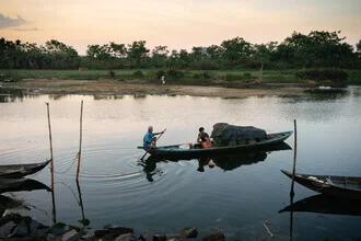 Fishermen in Hoi An at sunset: tranquil scene by the water