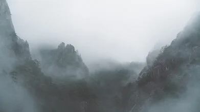 Misty mountain landscape in Huangshan, China, creating a calm and mysterious vibe.