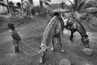 Photo art by Björn Groß: child with horse in a village in Fiji