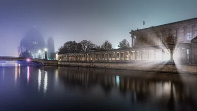 Photo art of the Berlin Cathedral at night, featuring soft lights and reflections on the water.