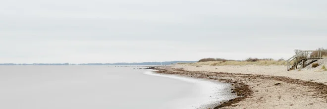 Long exposure of a beach at the Baltic Sea with gentle waves and a calm mood