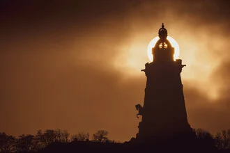 Kyffhäuser Monument enveloped in soft fog, autumn light creating a serene atmosphere.