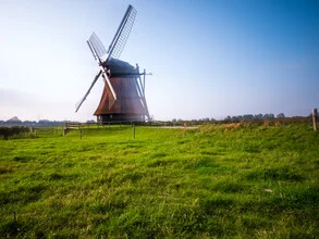 Photo art by Vision Praxis: Windmill at the North Sea with gentle waves in the background