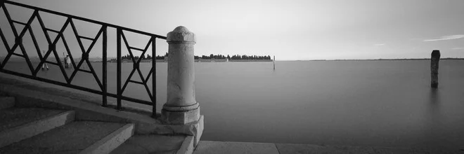 Panorama of Venice: calm water surface with historical buildings in the background