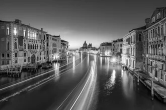 Charming night photo of the Canal Grande in Venice, featuring gentle lights and reflective water.