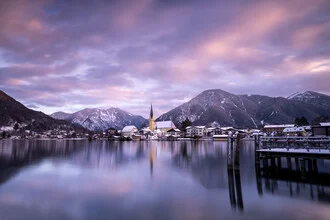 Red clouds over Lake Tegernsee at sunset, calm water surface.