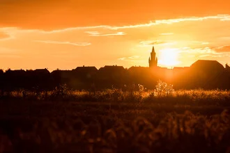 Sunrise behind the tower in Friedberg: soft colors and calm atmosphere