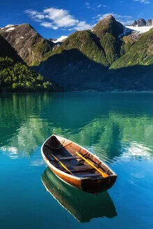 Calm lake in Hjelle, Norway, featuring a boat floating on the water