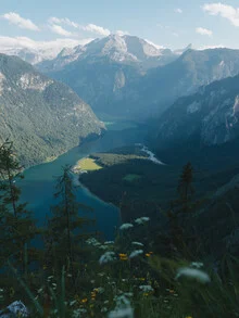Photo art by Lukas Gleich: tranquil mountain lake reflecting the surrounding peaks.