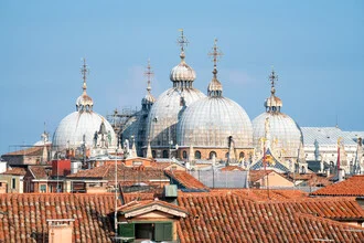 View of St. Mark's Basilica in Venice featuring its domes and intricate architectural details