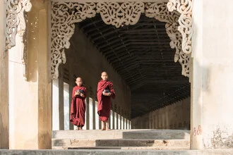 Two Buddhist monks in Bagan, serene atmosphere with temples in the background