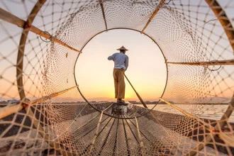 Intha fisherman on Inle Lake in Myanmar rowing in soft colors